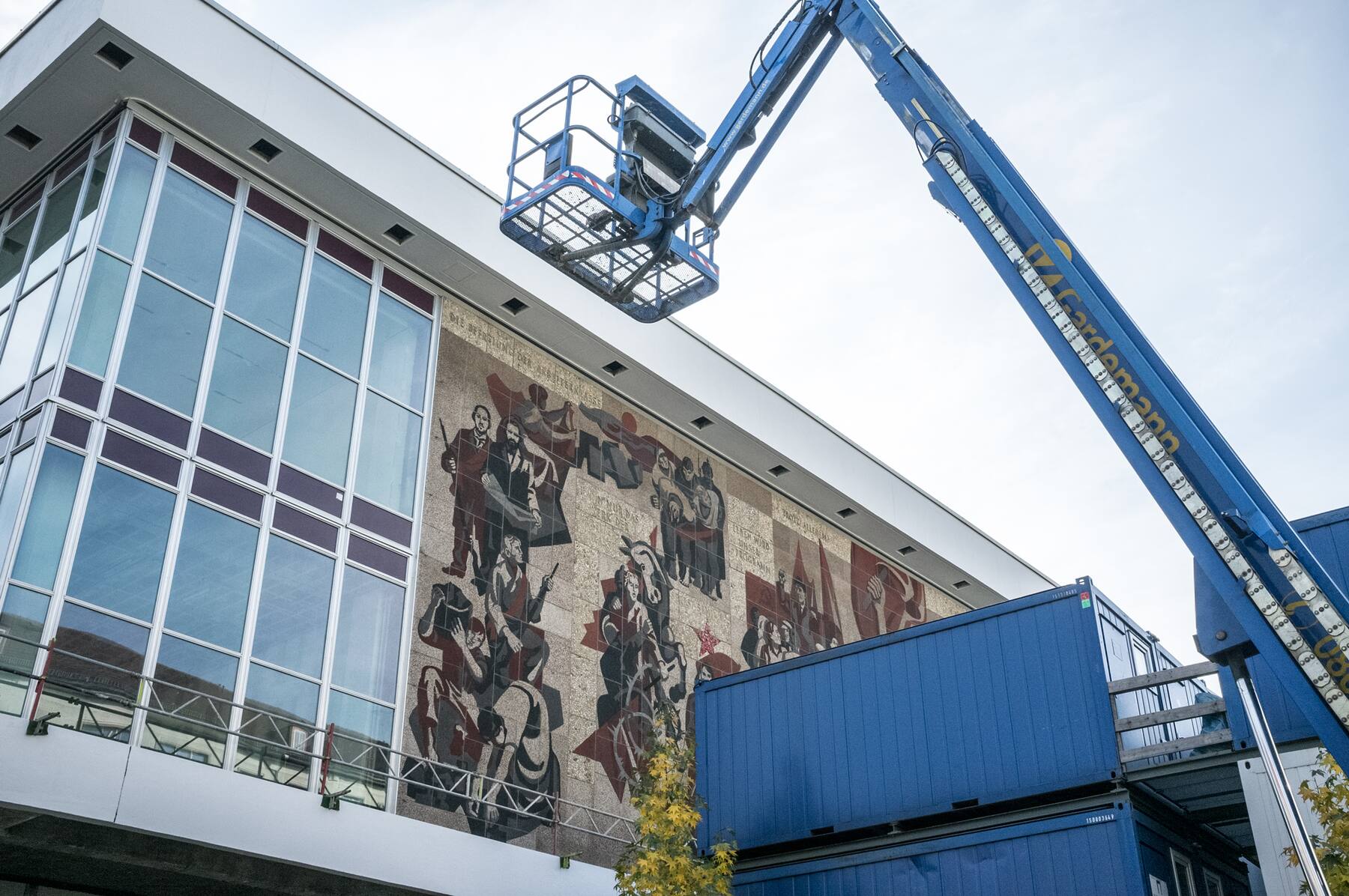 Socialist mural on the Kulturpalast behind scaffolding and a crane