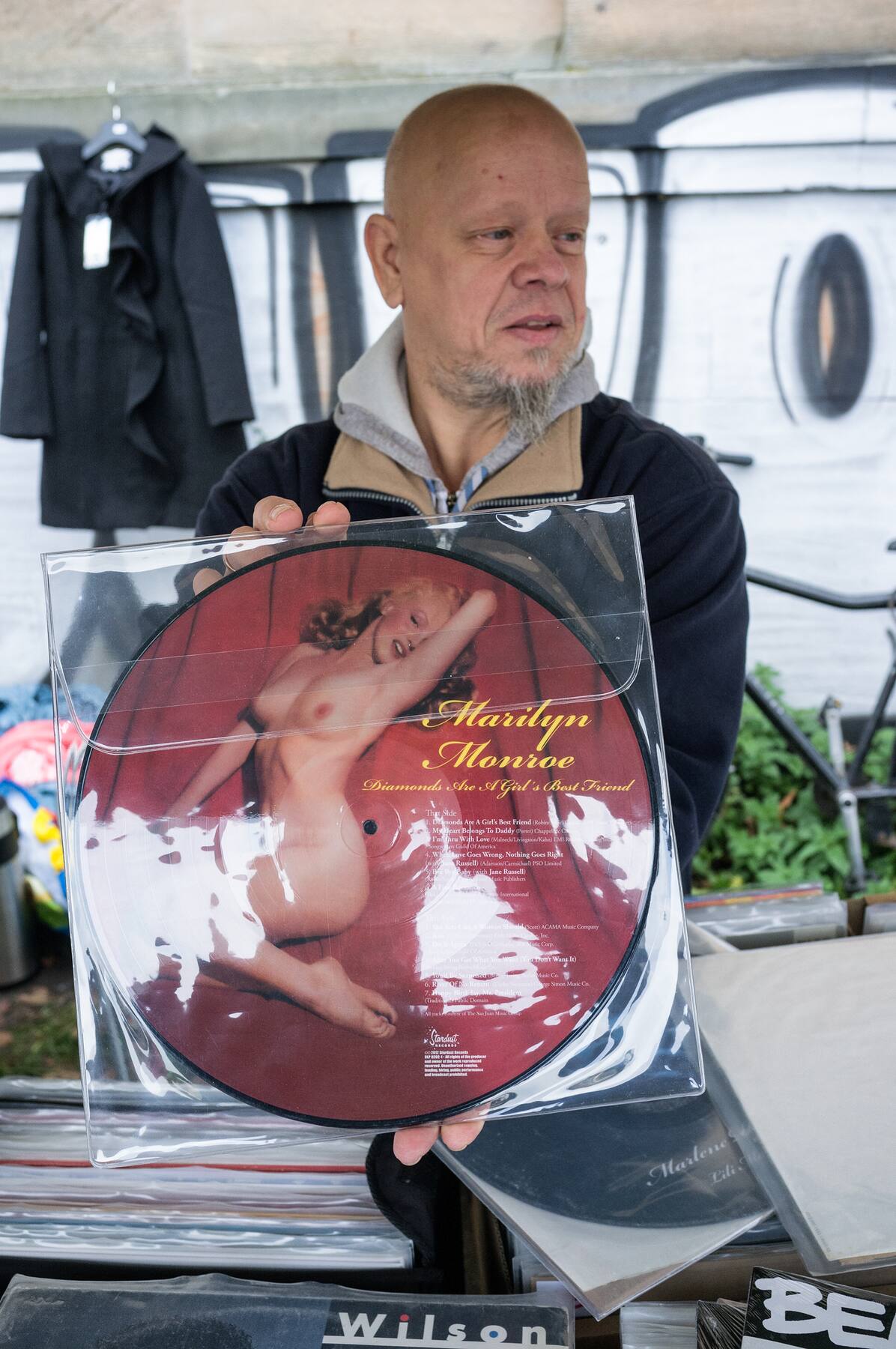 A seller proudly presenting a Marilyn Monroe picture disc