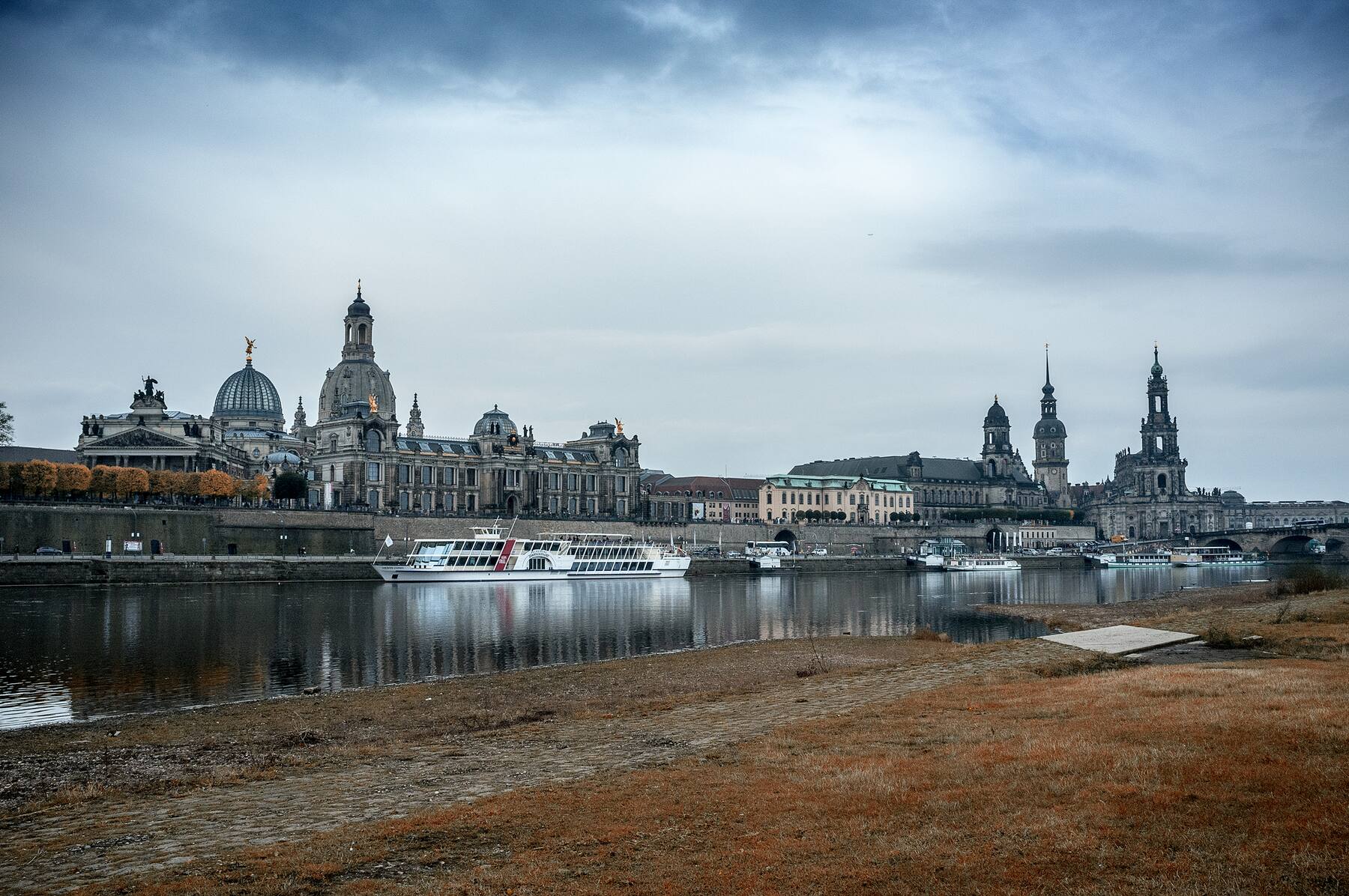 Dresden Altstadt skyline across the Elbe under heavy clouds