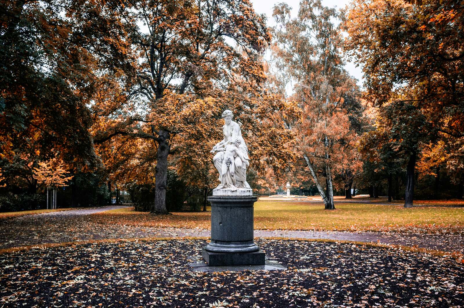 Marble statue among autumn trees