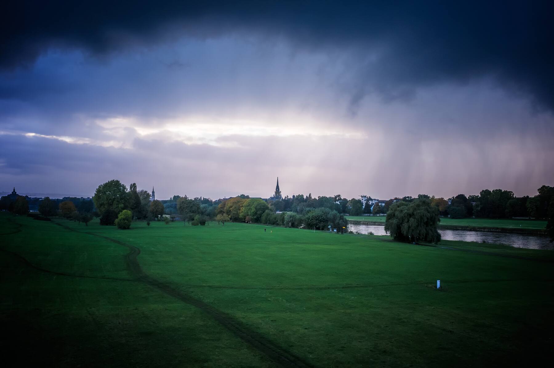 A curtain of rain crossing the Elbe meadows