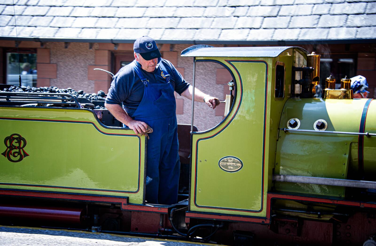 The driver oiling the little locomotive